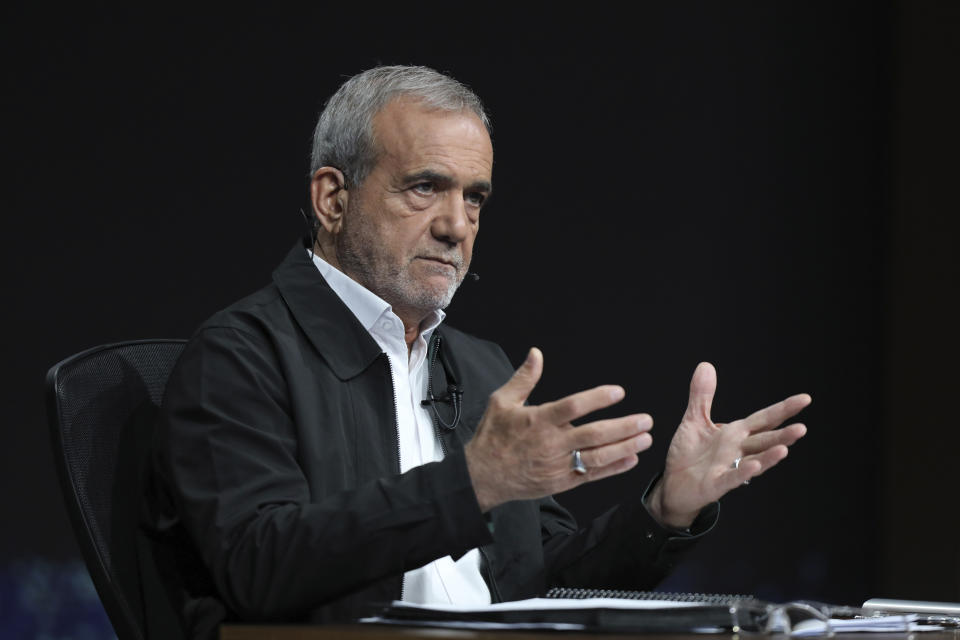 In this photo made available by Iranian state-run TV, IRIB, Iranian presidential candidate reformist Masoud Pezeshkian speaks during a debate with hard-line candidate Saeed Jalili at the TV studio in Tehran, Iran, Tuesday, July 2, 2024. Iran will hold a runoff presidential election Friday, only its second since the 1979 Islamic Revolution, after only 39.9% of its voting public cast a ballot the previous week. (Morteza Fakhri Nezhad/IRIB via AP)