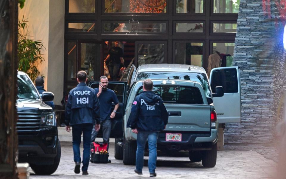 Homeland Security Investigations agents are seen at Sean's entrance 