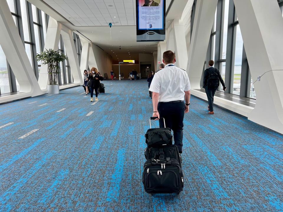 Airline pilot walking through an airport.