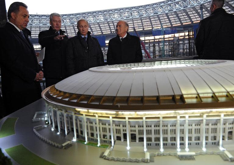 (L-R) Russian Sport Minister Vitaly Mutko, Moscow's Mayor Sergey Sobyanin, Russian President Vladimir Putin and FIFA President Sepp Blatter look at the model of Luzhniki stadium during their inspection in Moscow on October 28, 2014