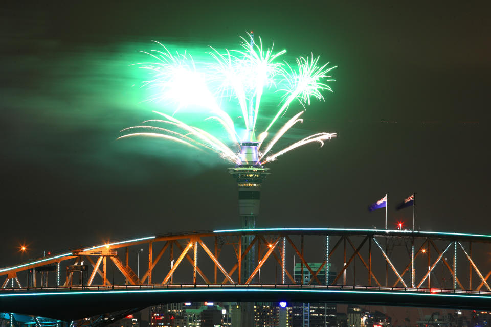 Fireworks are seen exploding from the Sky Tower with the Auckland Harbour Bridge in the foreground during the Auckland New Year's Eve celebrations on January 01, 2019 in Auckland, New Zealand.