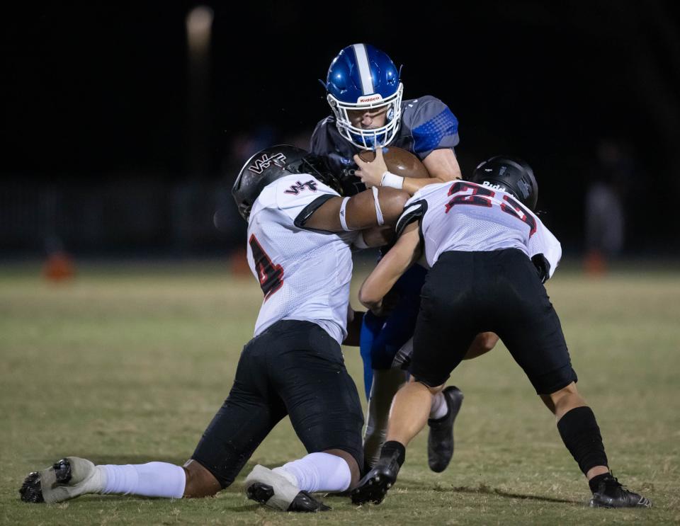 Quarterback Davis Sherman (10) is stopped by Ahmarion Moultrie (4) and Wyatt Casey (22) during the West Florida vs Washington football game at Booker T. Washington High School in Pensacola on Friday, Sept. 2, 2022.