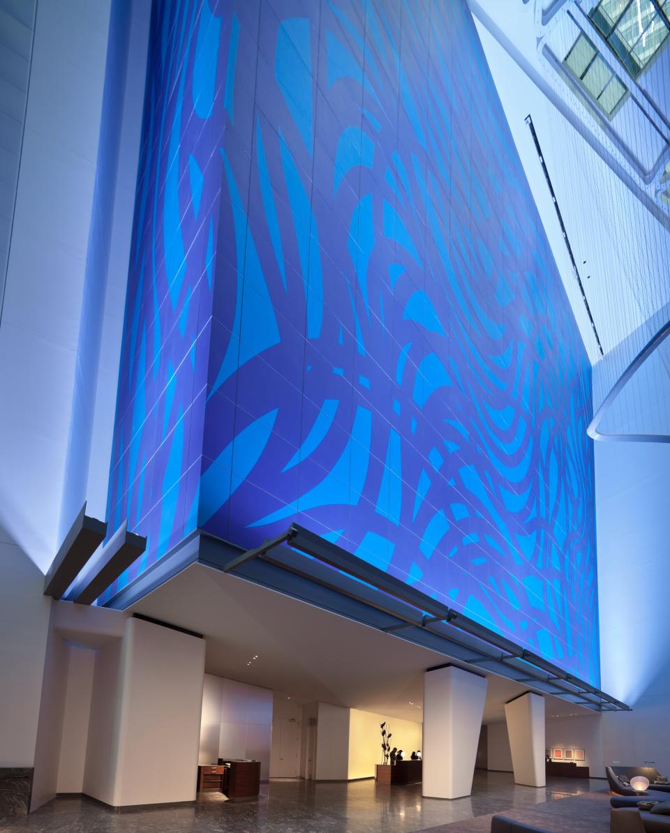 This undated photo supplied by Hilton Worldwide shows a 13-story work, "Loopy Doopy," by Sol Lewitt in the lobby of the Conrad New York hotel in Manhattan. Each guest room has a tile on display representing part of the work and the tiles are also sold in the hotel boutique, part of a trend of hotels differentiating themselves with unique works of art and then offering copies of the art for guests to purchase. (AP Photo/Conrad New York)