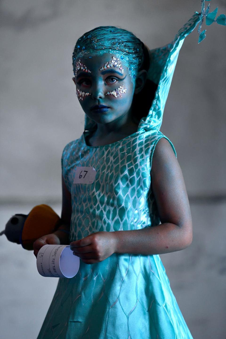 Chole Delaney, 7, waits her turn, dressed as the Ocean, based on illustrator Loren Long's work "If I was the Sunshine," before the costume contest at last year's Children's Art & Literacy Festival.