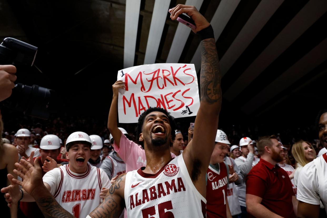 Feb 21, 2024; Tuscaloosa, Alabama, USA; Alabama Crimson Tide guard Aaron Estrada (55) celebrates with fans after they defeated the Florida Gators in overtime at Coleman Coliseum. Mandatory Credit: Butch Dill-USA TODAY Sports