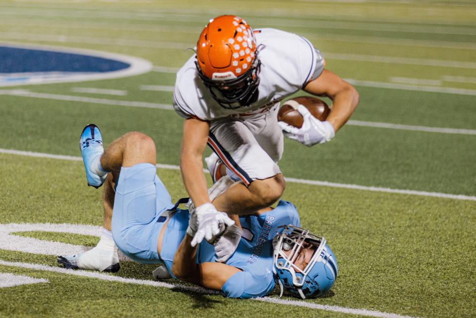 Bartlesville's Kaden Brown pulls down Tahlequah's Beckett Robinson during fierce grid action in November 2022 at Custer Stadium. The 28-16 win guaranteed Bartlesville the No. 5 playoff seed.