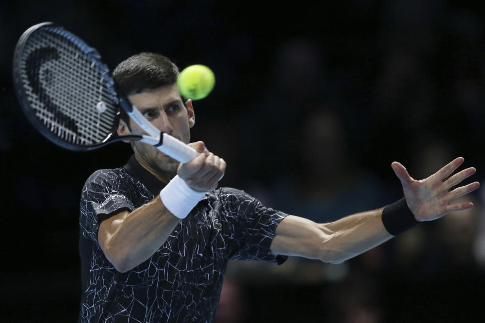 Novak Djokovic of Serbia plays a return to Kevin Anderson of South Africa in their ATP World Tour Finals singles tennis match at the O2 Arena in London, Saturday Nov. 17, 2018. (AP Photo/Tim Ireland)