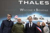 Ukrainian Minister of Defense Oleksii Reznikov, center left, poses with Chairman and CEO of Thales Group Patrice Caine, and French Defense Minister Sebastien Lecornu, third right, and mayor of Limours Chantal Thiriet, second right, during a visit at Thales radar factory in Limours, south west of Paris, France, Wednesday, Feb. 1, 2023. France has guaranteed Kyiv the delivery of a Ground Master 200 (GM200) radar, produced by the French manufacturer Thales. This medium-range radar is capable of spotting enemy aircraft at 250 km and engaging them at 100 km, whether they are flying at low speed and low altitude like drones or at high altitude like fighter planes. (AP Photo/Christophe Ena)