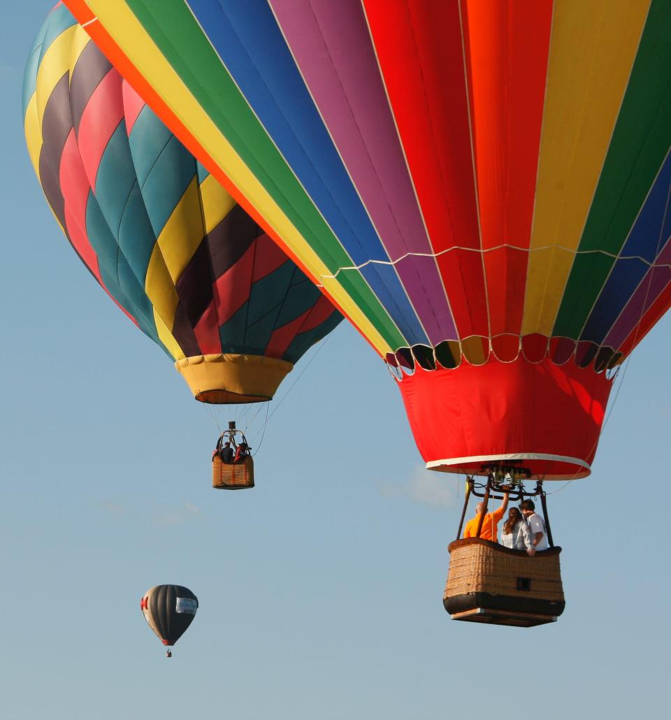 People in hot air balloons at the New Jersey Lottery Festival of Ballooning.