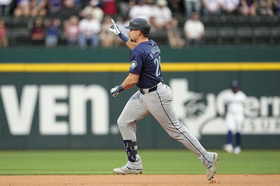 Seattle Mariners' Cal Raleigh celebrates his two-run home run in the first inning of a baseball game against the Texas Rangers in Arlington, Texas, Tuesday, April 23, 2024. (AP Photo/Tony Gutierrez)