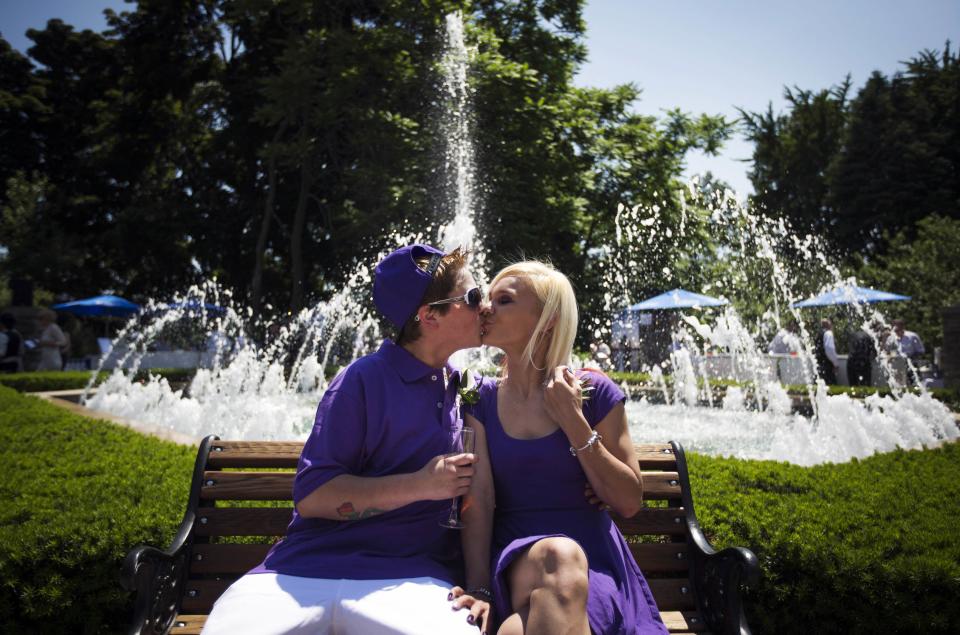 Shenice and Victoria Hynes kiss before "The Celebration of Love" grand wedding where over 100 LGBT couples will get married at Casa Loma in Toronto