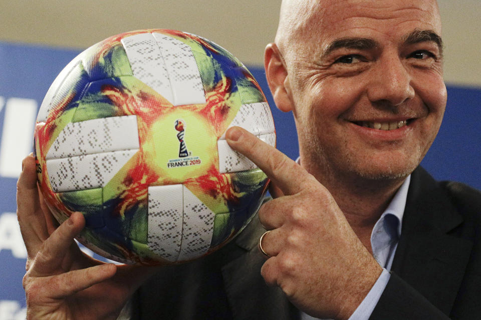 FILE - In this Feb. 27, 2019, file photo, FIFA President Gianni Infantino holds the official ball of the upcoming Women’s Soccer World Championship as he poses for photographers during a press conference at the end of an executive committee meeting in Rome. FIFA's financial results underscore the glaring disparity between men and women’s soccer. “We need to try to find what is the most balanced way and I think we made a step and there will be many more steps going ahead,” Infantino said in October before his ruling council approved the 2019 Women’s World Cup prize scale. (AP Photo/Gregorio Borgia, File)