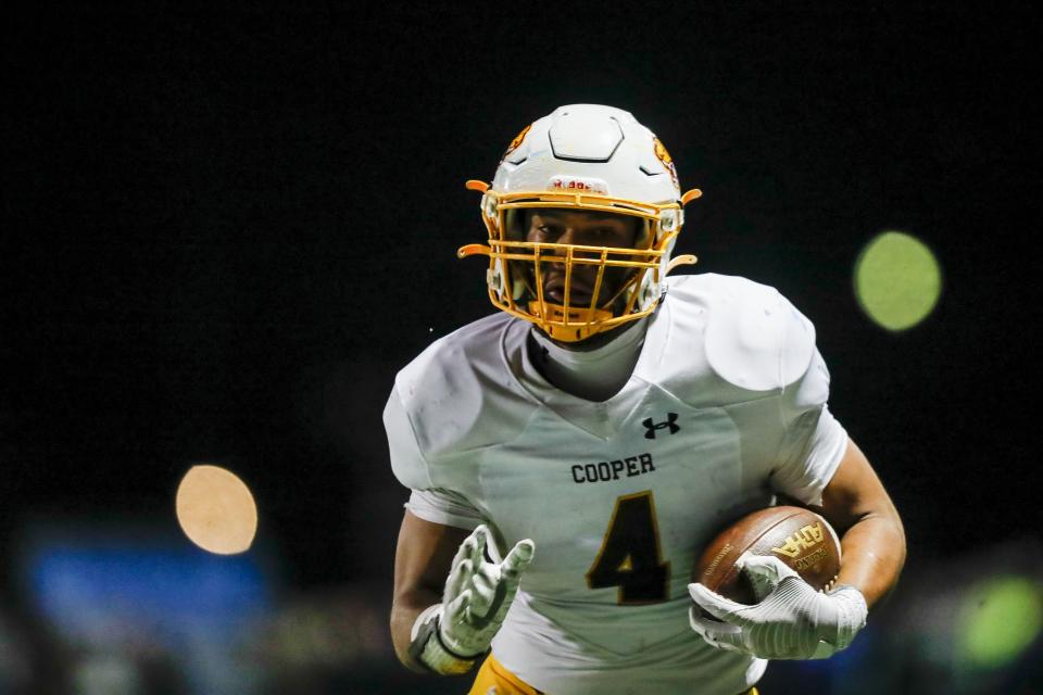 Cooper tight end Austin Alexander (4) runs with the ball for a touchdown against Highlands in the first half at Highlands High School on Nov. 24.