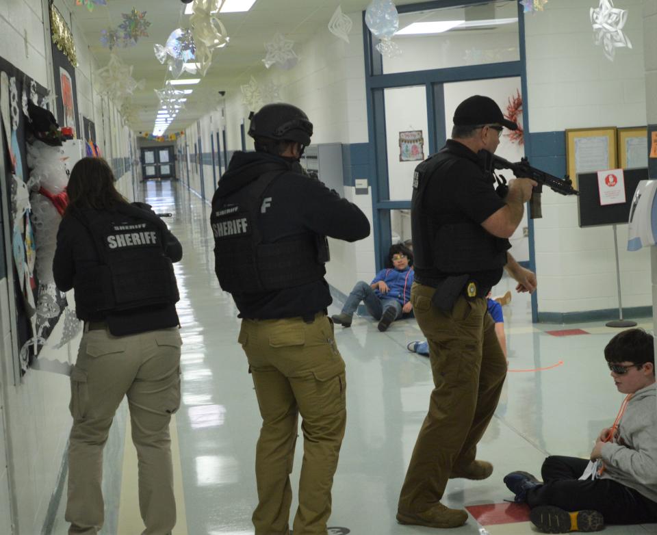 A team of officers sweeps the halls of Glascock County Consolidated School after subduing a gunman in a training exercise held Wednesday, Dec. 21.