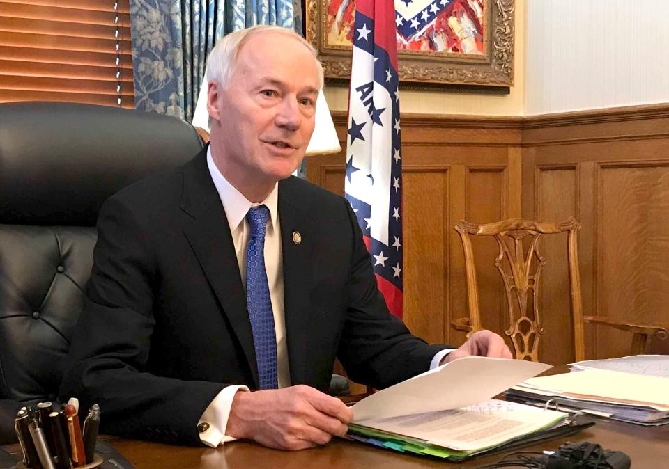 Arkansas Gov. Asa Hutchinson, speaking in his office at the state Capitol in Little Rock, Ark., on April 10, 2019, tells reporters he'll sign legislation cutting off funding to "sanctuary cities" that don't cooperate with federal immigration authorities.