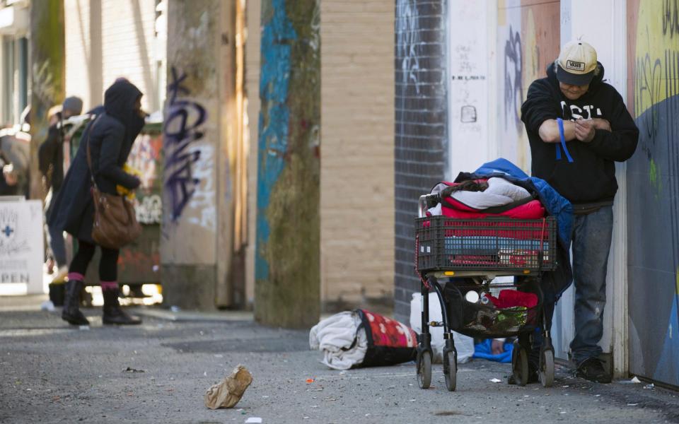 A man injects drugs in Vancouver. British Columbia has had to make changes to its drug policy after users took to streets and parks to take drugs