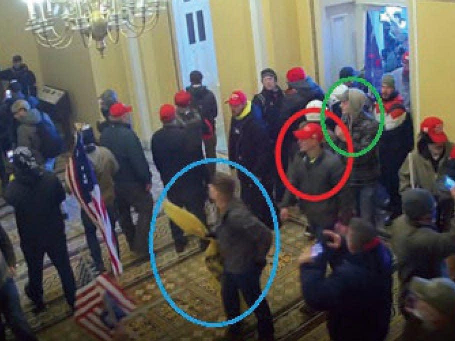 In this image from U.S. Capitol Police video, released and annotated by the Justice Department in the Statement of Facts supporting an arrest warrant, Joshua Abate, circled in green, Micah Coomer, circled in red, and Dodge Dale Hellonen, circled in blue, appear inside the U.S. Capitol on Jan. 6, 2021, in Washington. Abate and Hellonen, who were active-duty members of the Marines Corps when they stormed the U.S. Capitol, pleaded guilty on Monday, June 12, 2023, to riot-related criminal charges. Coomer, who was an active-duty Marine, pleaded guilty to the same misdemeanor charge in May.