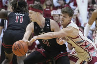 Rutgers guard Paul Mulcahy (4) is defended by Indiana forward Miller Kopp (12) during the second half of an NCAA college basketball game Tuesday, Feb. 7, 2023, in Bloomington, Ind. (AP Photo/Darron Cummings)