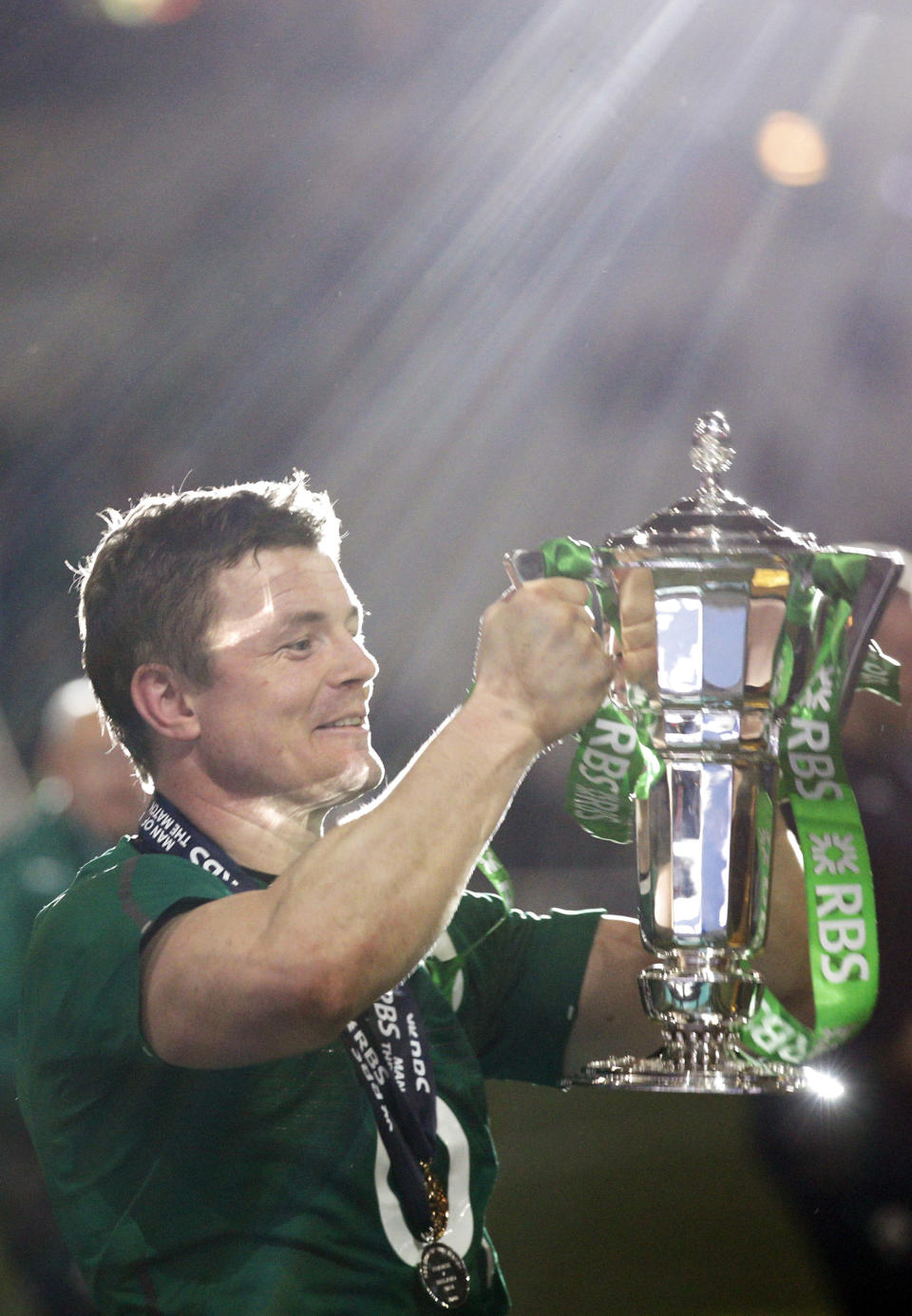Ireland's Brian O'Driscoll celebrates with the trophy after defeating France and winning the Six Nations Rugby Union tournament at the Stade de France stadium, in Saint Denis, outside Paris, Saturday, March 15, 2014. (AP Photo/Christophe Ena)