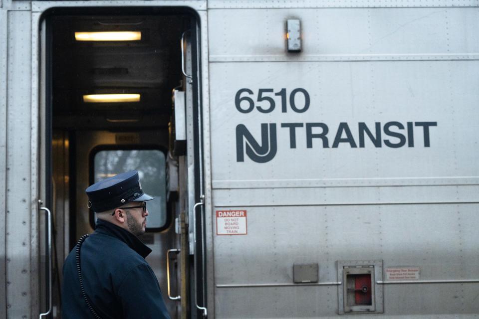 A conductor waits for passengers to board an NJ Transit train at the Clifton Station on Thursday April 11, 2024.