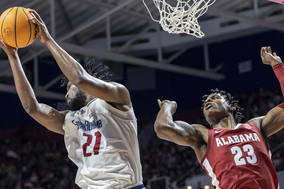 South Alabama center Kevin Samuel (21) rebounds the ball away from Alabama forward Nick Pringle (23) during the first half of an NCAA college basketball game, Tuesday, Nov. 15, 2022, in Mobile, Ala. (AP Photo/Vasha Hunt)