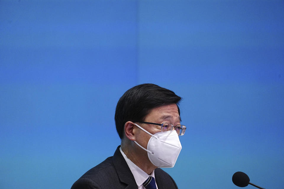 Hong Kong Chief Executive John Lee speaks during a news conference in Hong Kong, Friday, Sep. 23, 2022. Hong Kong's leader announced the city would no longer require incoming travelers to quarantine in designated hotels as the city seeks to open up globally after nearly two years. (AP Photo/Lam Yik)