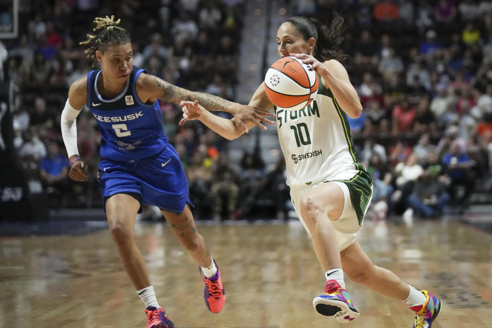 Seattle Storm guard Sue Bird (10) drives against Connecticut Sun guard Natisha Hiedeman (2) during the first half of a WBNA basketball game Thursday, July 28, 2022, in Uncasville, Conn. (AP Photo/Bryan Woolston)