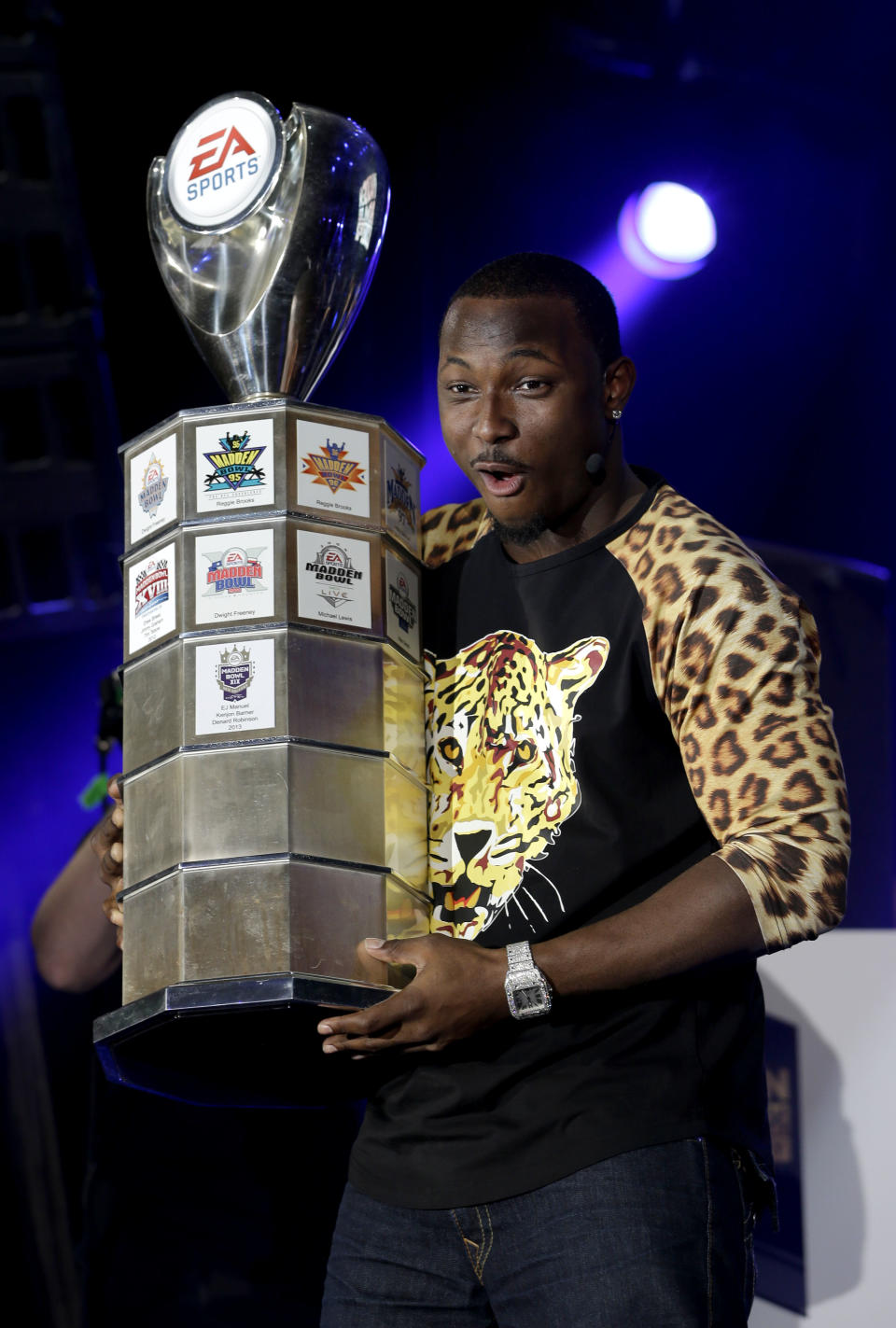 This Jan. 30, 2014 photo shows Philadelphia Eagles' LeSean McCoy holding a trophy after winning the Madden Bowl video game tournament held next to the Bud Light Hotel in New York. Norwegian Cruise Line’s just-launched ship Norwegian Getaway is serving as a floating hotel for Super Bowl weekend events sponsored by the beer brand Bud Light. Renamed the Bud Light Hotel New York, the ship is docked at Pier 88 in Manhattan on the Hudson. Its 18 decks house 4,000 guests in 1,900 staterooms. Those aboard are mostly connected to Bud Light's retailers, partners and VIP guests. (AP Photo)
