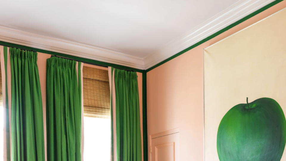 a bedroom with a green curtains