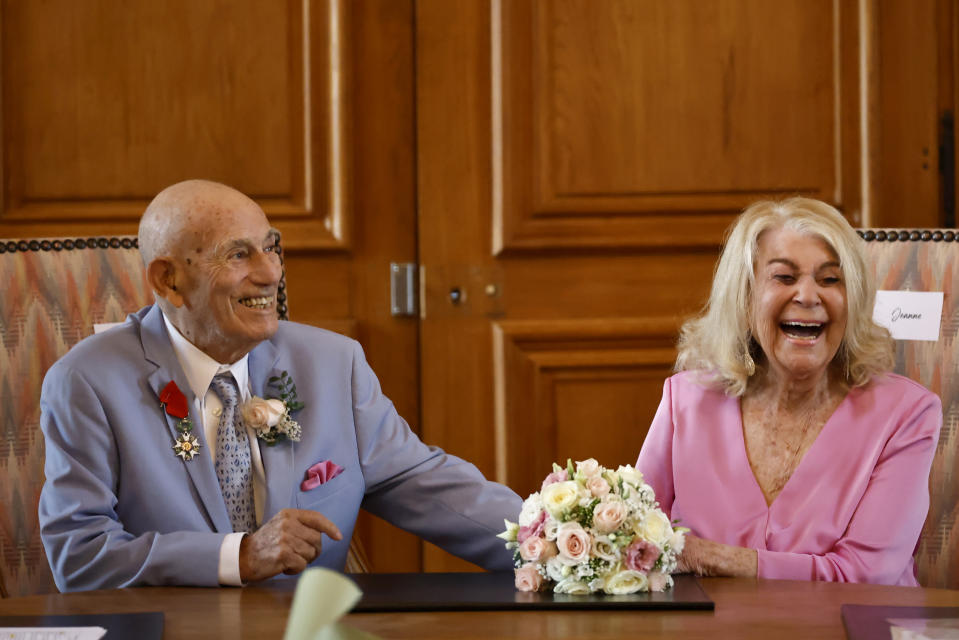 US WWII veteran Harold Terens, 100, left, and Jeanne Swerlin, 96, celebrate their wedding at the town hall of Carentan-les-Marais, in Normandy, northwestern France, on Saturday, June 8, 2024. Together, the collective age of the bride and groom was nearly 200. But Terens and his sweetheart Jeanne Swerlin proved that love is eternal as they tied the knot Saturday inland of the D-Day beaches in Normandy, France. (AP Photo/Jeremias Gonzalez)