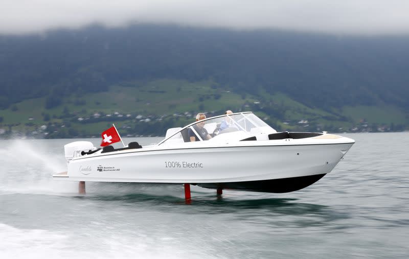 Vogel steers electric powered Candela Seven boat on Lake Lucerne near Luzern