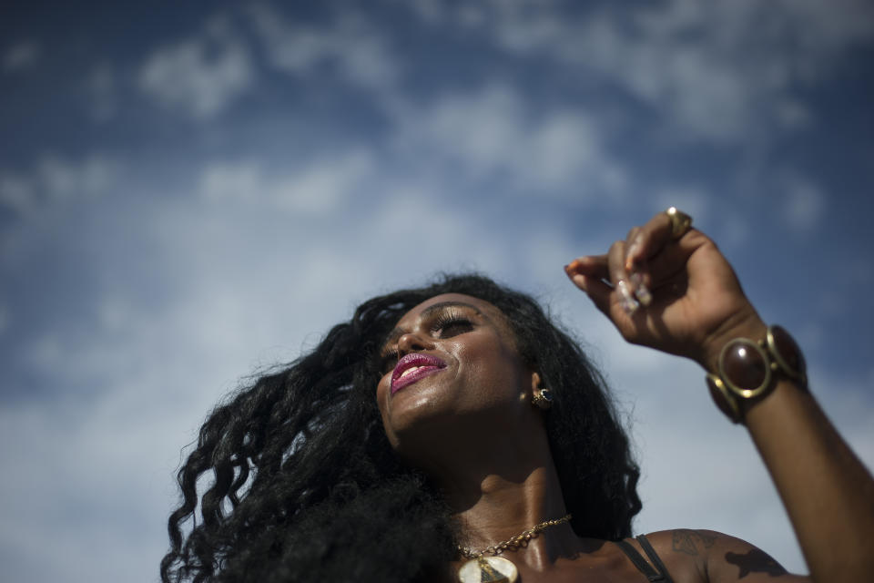 A reveler dances during the "Bloco da Favorita" street party on Copacabana beach, Rio de Janeiro, Brazil, Sunday, Jan. 12, 2020. Copacabana beach hosted the kick-off to the 50-day Countdown to Carnival with a concert and the "election" of King Momo to preside over festivities. (AP Photo/Bruna Prado)