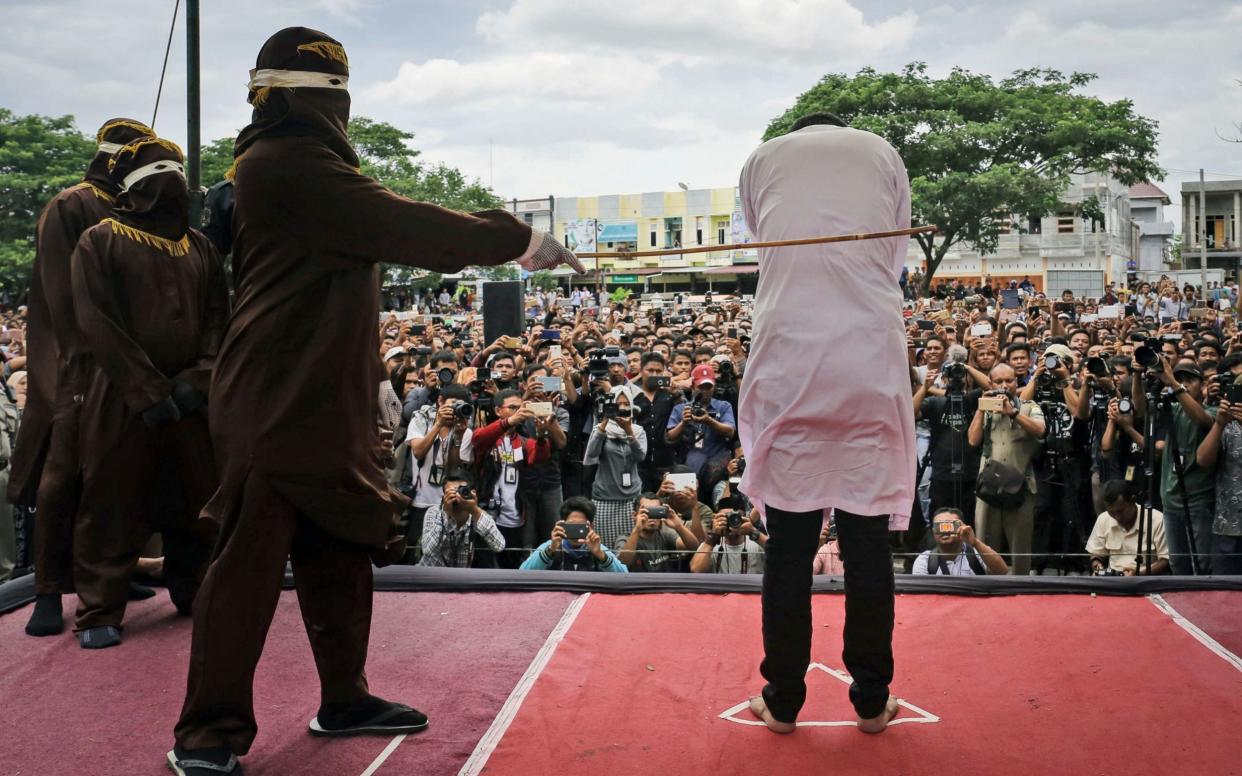 Aceh already frequently carries out the public caning of gay people and alleged adulterers and gamblers - AP