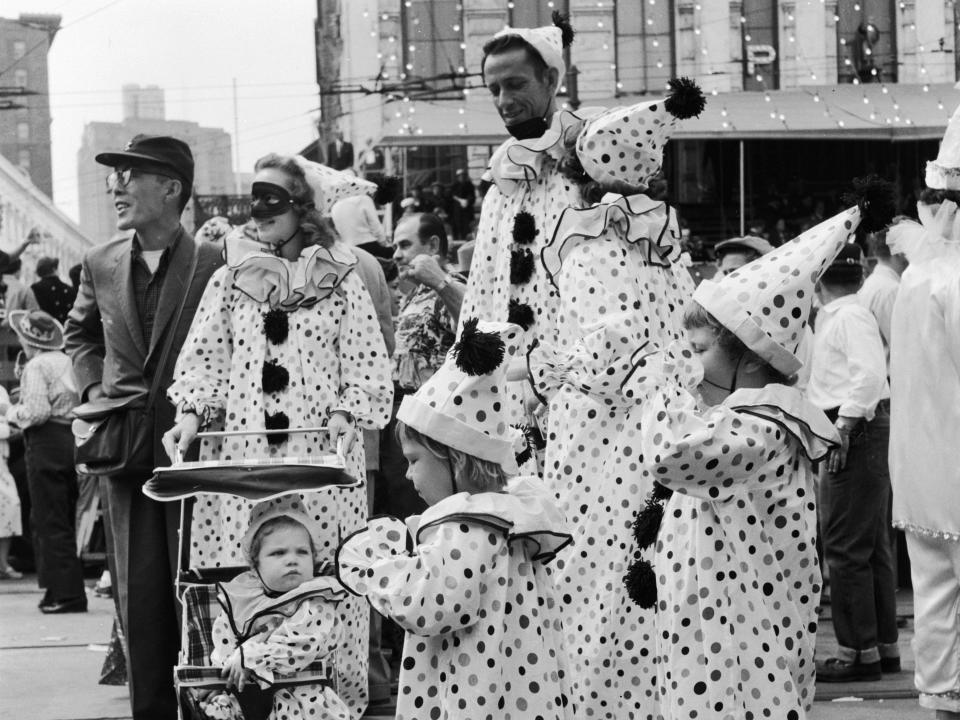 vintage clowns dressed in polka dots at a parade in black and white