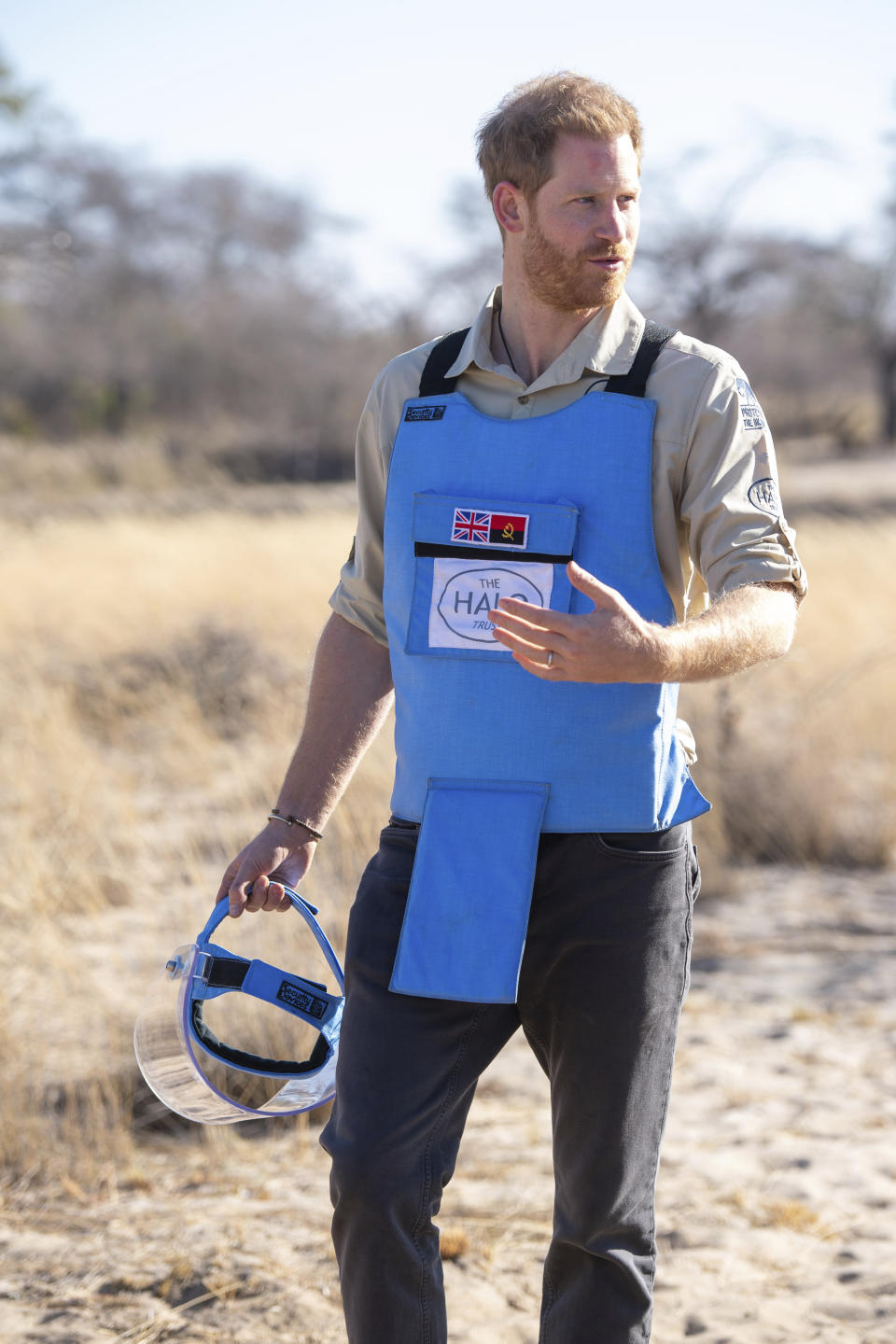 Britain's Prince Harry walks through a minefield in Dirico, Angola Friday Sept. 27, 2019, during a visit to see the work of landmine clearance charity the Halo Trust, on day five of the royal tour of Africa. Prince Harry is following in the footsteps of his late mother, Princess Diana, whose walk through an active mine field in Angola years ago helped to lead to a global ban on the deadly weapons. (Dominic Lipinski/Pool via AP)