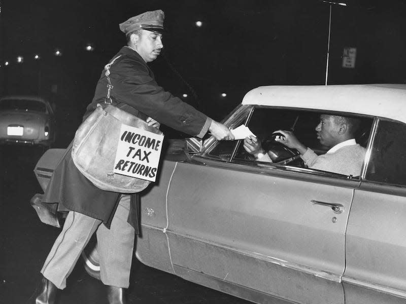 A postal worker collects income tax returns in 1965