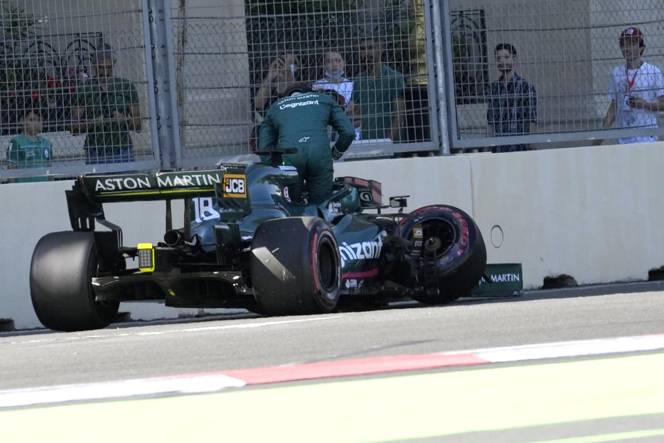 Aston Martin driver Lance Stroll of Canada gets out of his car after a crash during the qualifying session at the Baku Formula One city circuit in Baku, Azerbaijan, Saturday, June 5, 2021. The Azerbaijan Formula One Grand Prix will take place on Sunday. (AP Photo/Darko Vojinovic)