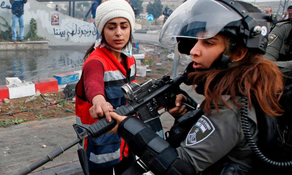 An unarmed Palestinian protester confronts an Israeli border guard north of Ramallah, in the Israeli-occupied West Bank, on Friday.