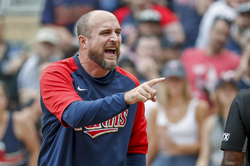 Minnesota Twins manager Rocco Baldelli, right, argues with umpires after a review reversed a call that originally had Toronto Blue Jays' Whit Merrifield out at home in the 10th inning of a baseball game Sunday, Aug. 7, 2022, in Minneapolis. The Blue Jays won 3-2 in 10 innings. (AP Photo/Bruce Kluckhohn)