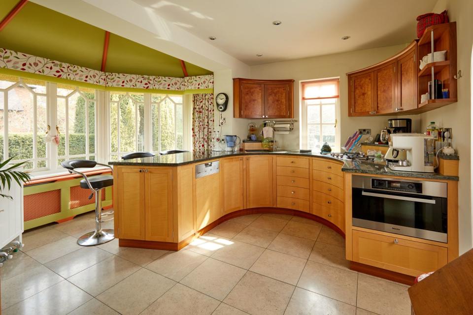 a kitchen with wooden cabinets