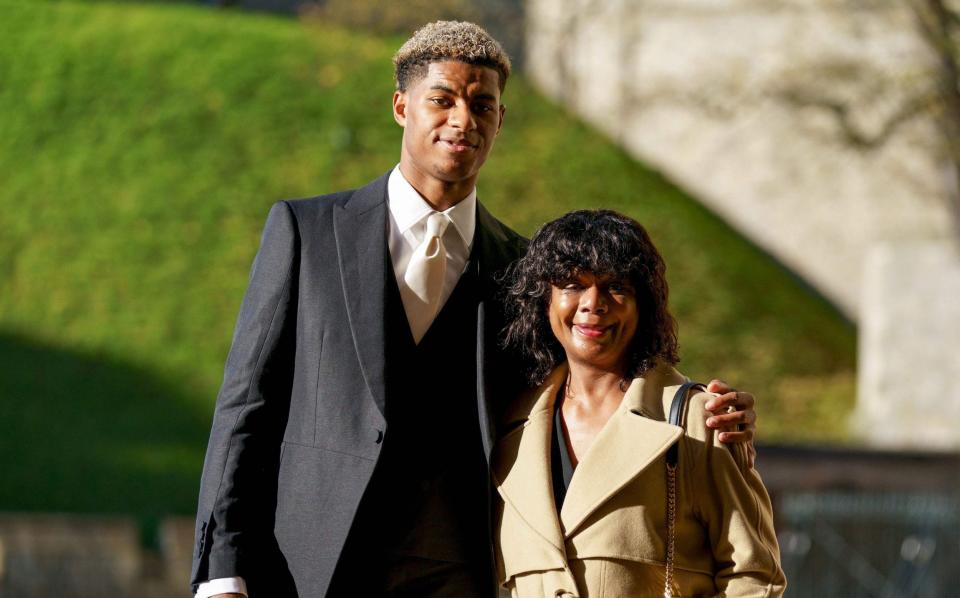 Marcus Rashford poses with his mother Melanie Rashford before being appointed Member of the Order of the British Empire (MBE) for services to the vulnerable in Britain during the Covid-19 pandemic