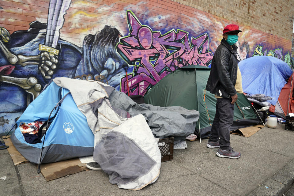 FILE - Sotero Cirilo stands near the tent where he sleeps next to other homeless people in the Queens borough of New York on April 14, 2021. The City Council unanimously approved a “Homeless Bill of Rights” in April 2023 that would make New York the first big U.S. city to establish an explicit right to sleep in at least some public places. If Mayor Eric Adams, a Democrat, allows the measure to become law, it could be a notable departure for the city — which has for years sent police and sanitation crews to clear homeless encampments as they arise. (AP Photo/Seth Wenig, File)