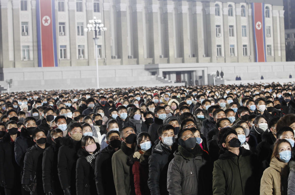 People watch the national flag raising ceremony and fireworks display to celebrate the New Year, at Kim Il Sung Square in Pyongyang, North Korea, early Friday, Jan., 1, 2021. (AP Photo/Jon Chol Jin)