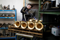 A worker forms the bells of saxophones at the Henri Selmer wind instruments factory in Mantes-la-Ville near Paris, France, January 17, 2018. REUTERS/Benoit Tessier