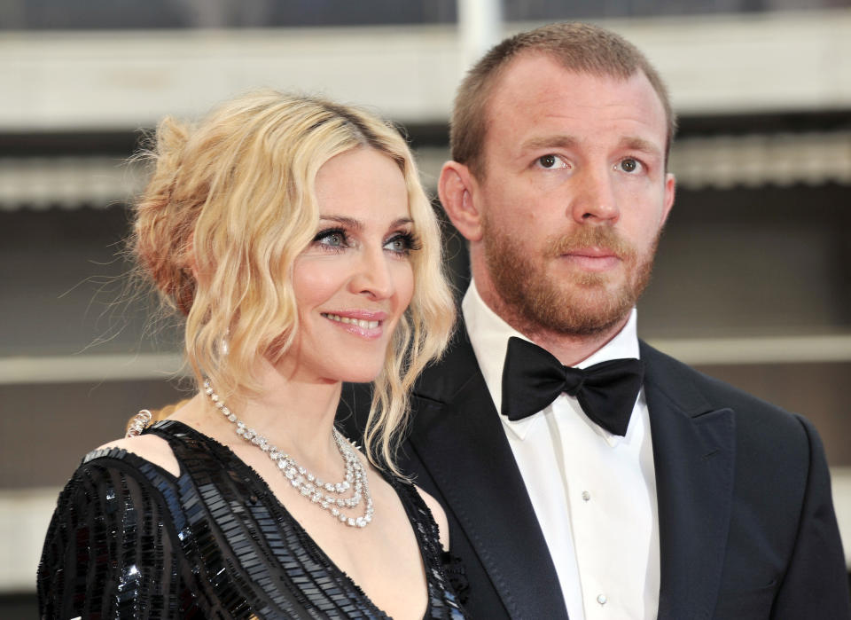 US singer Madonna (L) and her husband British director Guy Ritchie pose as they arrive to attend the screening of Nathan Rissman's film 'I Am Beacuse We Are' at the 61st Cannes International Film Festival on May 21, 2008 in Cannes, southern France. The May 14-25 festival winds up with the awards ceremony for the prestigious Palme d'Or, to be determined by a jury headed by Hollywood "bad boy" Sean Penn.       AFP PHOTO / ANNE-CHRISTINE POUJOULAT        (Photo credit should read ANNE-CHRISTINE POUJOULAT/AFP/GettyImages)