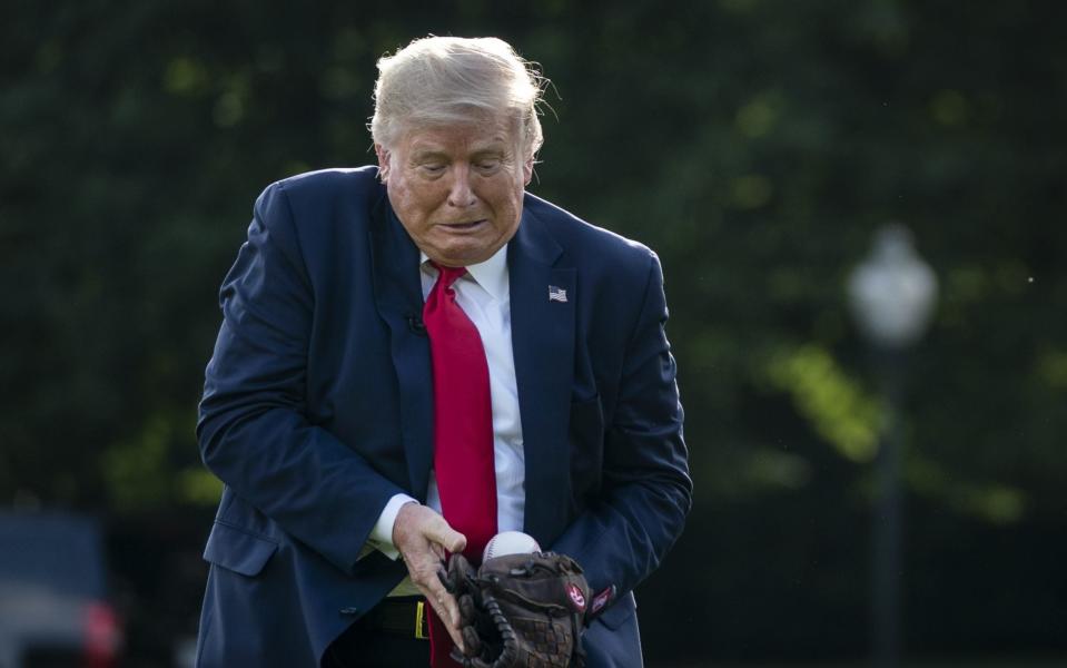 Donald Trump catches a baseball on the South Lawn of the White House in Washington, DC - Getty Images