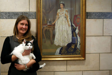 Laura Dauban, deputy ambassador of the United Kingdom to Jordan, poses with Lawrence of Abdoun, the first diplo-cat to be appointed by the British Embassy in Jordan, at the embassy headquarters in Amman, Jordan, November 15, 2017. REUTERS/Muhammad Hamed