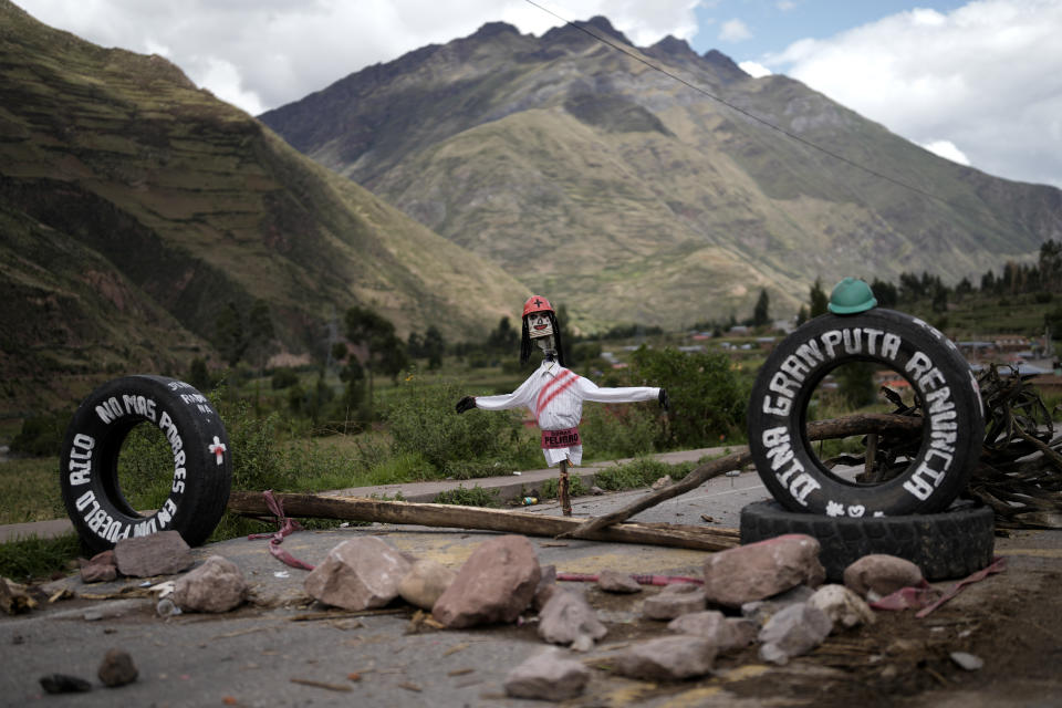 An effigy of President Dina Boluarte makes up part of a roadblock set up by demonstrators asking for the resignation of Boluarte, in Cusipata, Peru, Saturday, Jan. 28, 2023. Government officials said that police and the military will lift blockades set up around the country by supporters of former President Pedro Castillo who took to the streets after he was impeached and arrested for trying to dissolve Congress in December. (AP Photo/Rodrigo Abd)