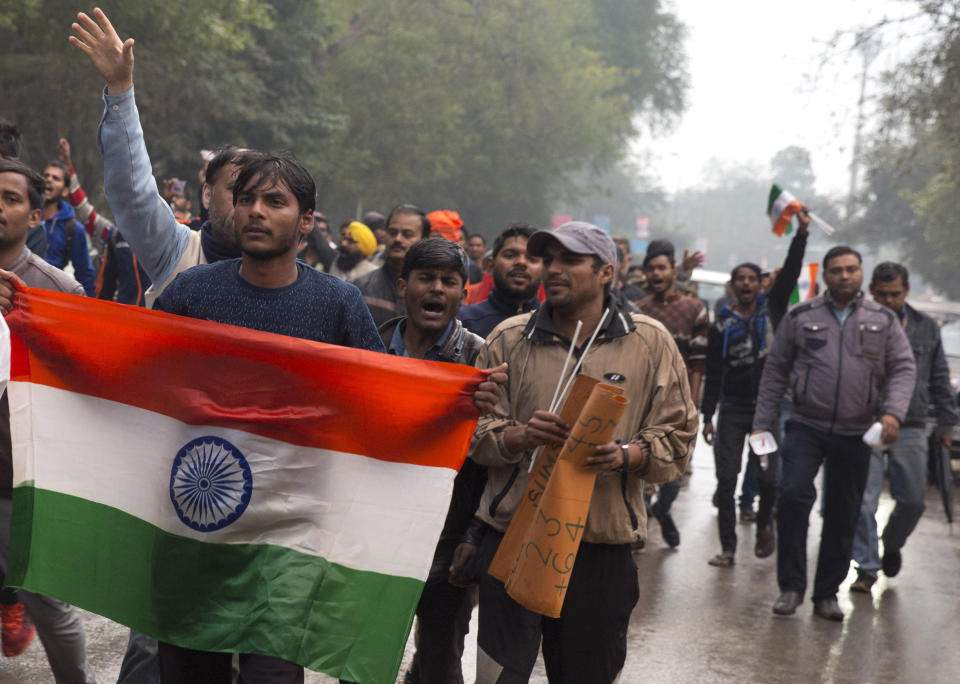 Indian protestors shout slogans against Thursday's attack on a paramilitary convoy in Kashmir, in Prayagraj, Uttar Pradesh state, India, Friday, Feb. 15, 2019. The death toll from a car bombing on a paramilitary convoy in Indian-controlled Kashmir has climbed to at least 40, becoming the single deadliest attack in the divided region's volatile history, security officials said Friday. (AP Photo/ Rajesh Kumar Singh)