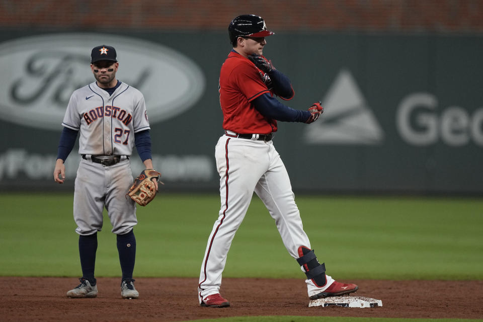 Atlanta Braves' Austin Riley celebrates his RBI-double during the third inning in Game 3 of baseball's World Series between the Houston Astros and the Atlanta Braves Friday, Oct. 29, 2021, in Atlanta. (AP Photo/David J. Phillip)